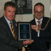 Dr Neil Mackay, Dumbarton FC chairman, receives a presentation from Provost Douglas McAllister. Image: Andy Scott