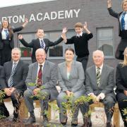 Pupils and staff posed outside their brand new school