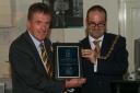 Dr Neil Mackay, Dumbarton FC chairman, receives a presentation from Provost Douglas McAllister. Image: Andy Scott