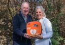James Fraser, Chair of the Friends, handing over a defibrillator to Lucy Fraser who raised over £1,000 for the installation of this life-saving equipment