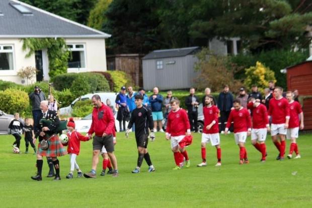 Colin Lawrie piped the teams out at DCF Park, while young Rosie McNicol was Rhu’s mascot on the day