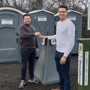 Sam Newell (left) from toilet suppliers Honeywagon is pictured handing over the keys to the temporary toilets sited at Duck Bay Car Park to Darroch Cawley (right) from the Cawley Group