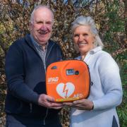 James Fraser, Chair of the Friends, handing over a defibrillator to Lucy Fraser who raised over £1,000 for the installation of this life-saving equipment