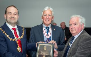 Provost Douglas McAllister and deputy lieutenant of Dunbartonshire, Tom Finnigan, MBE present Vale of Leven president Fergus McLellan with a plaque to mark the club's 150th anniversary